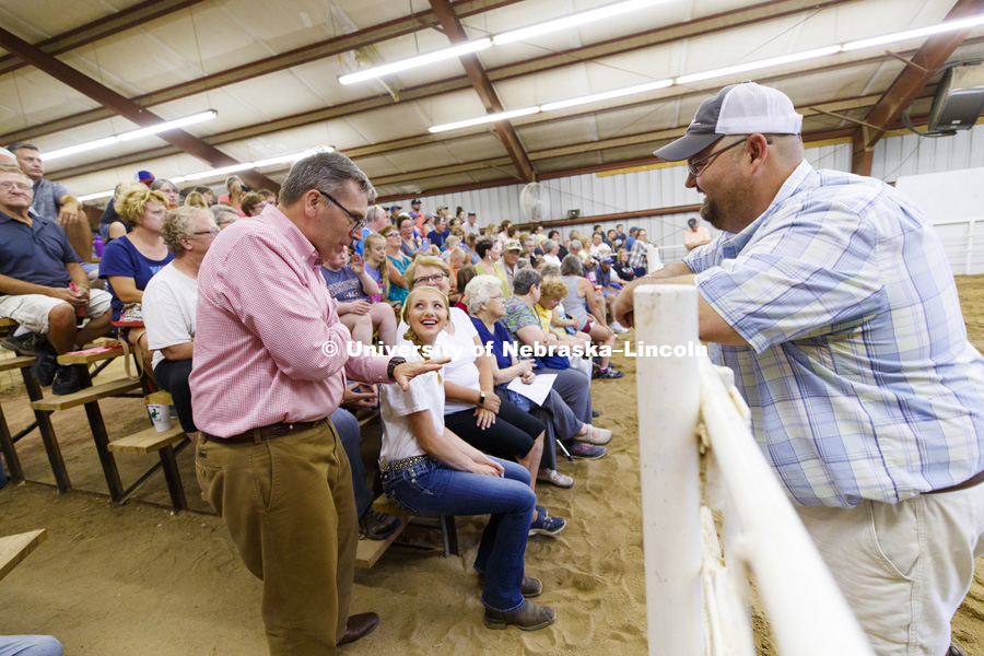 Kiley Weichel of Plymouth, Nebraska, smiles as Chancellor Ronnie Green relates a story of his youth showing cattle. Green was at the Jefferson County Fair Junior Beef Show in Fairbury, Nebraska. July 13, 2018. Photo by Craig Chandler / University