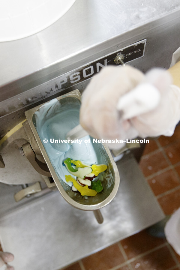 The sharks are added to the mix. Dairy Store making Shark Week ice cream with gummy sharks in a light blue ice cream. July 18, 2018. Photo by Craig Chandler / University Communication.