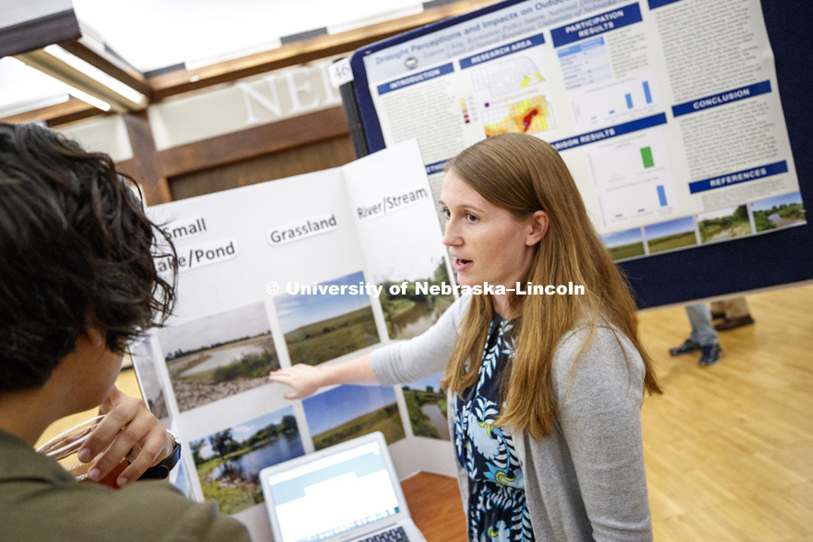 Lauren Uhlig explains her summer research "Drought Perception and Impacts on Outdoor Recreation in the Great Plains" during Tuesday's poster session. Summer Undergraduate Research Fair poster session in the Nebraska Union Ballroom. August 7, 2018. Photo
