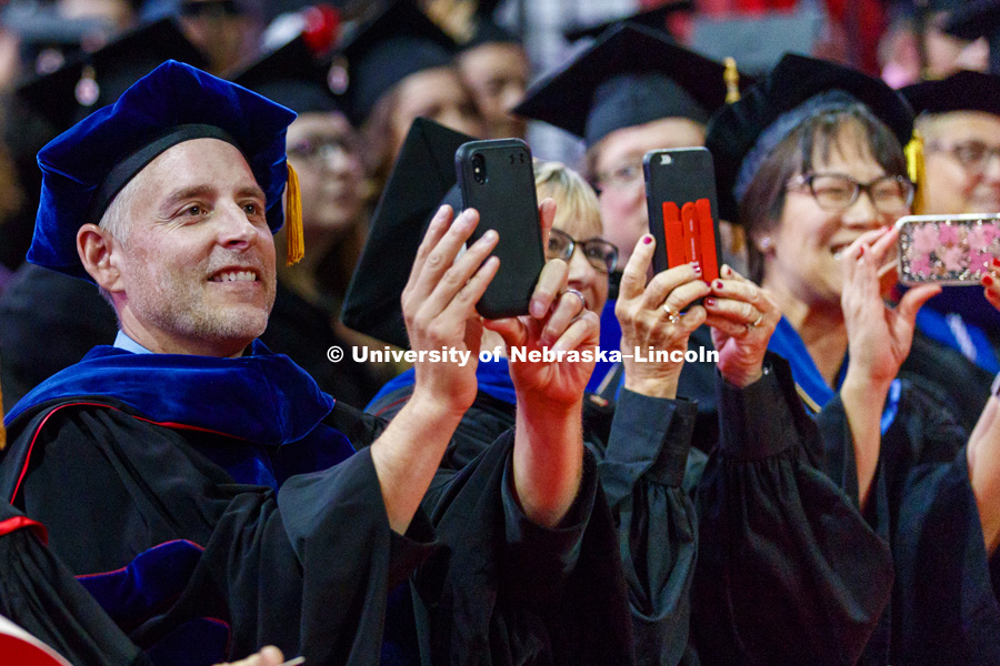 Faculty paparazzi photograph the doctoral hooding at Summer Commencement at Pinnacle Bank Arena. August 11, 2018. Photo by Craig Chandler / University Communication.