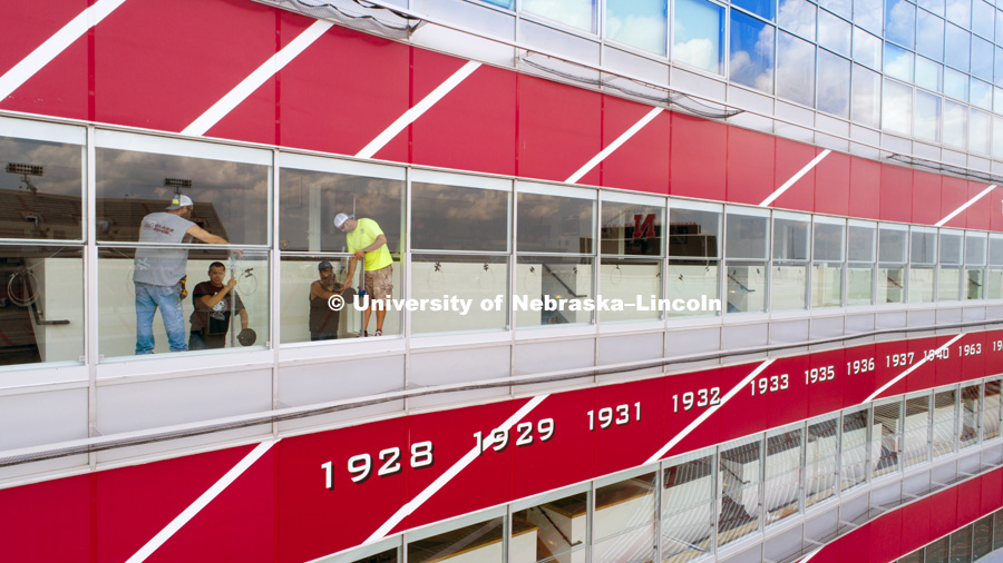 New windows being installed in the suites of west stadium use a new hinge that is designed and printed at Nebraska Innovation Studios. August 13, 2018. Photo by Craig Chandler / University Communication.