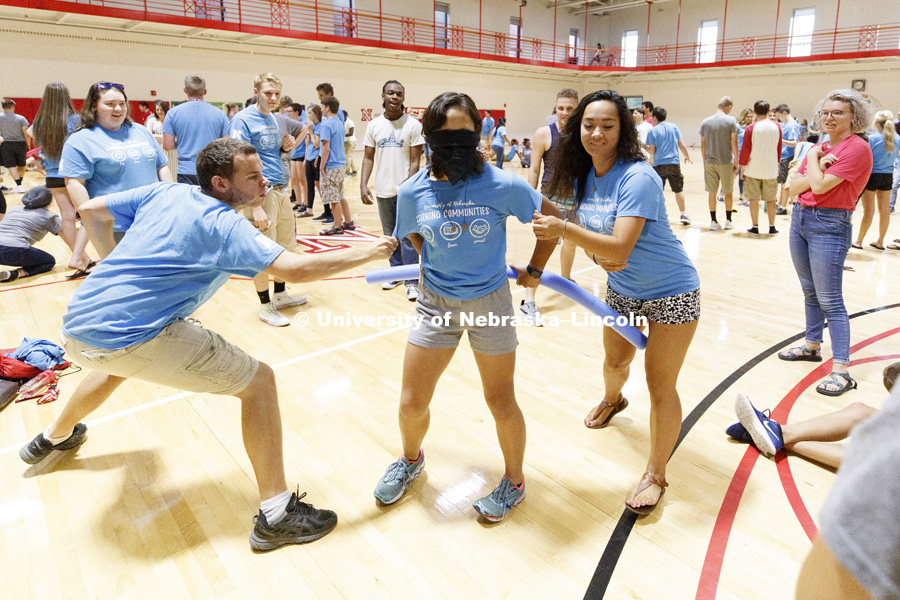 Sapphire Toth from San Francisco tries to fend off those trying to remove clothespins from her clothing in a game of Clothspin Ninja. Learning Community Welcome Event in the rec center. August 17, 2018. Photo by Craig Chandler / University Communication.