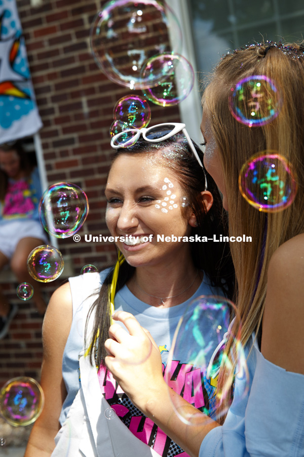 Alpha Chi Omege members pose for a photo as bubbles float through the air. Bid Day for Greek Sororities.  August 18, 2018. Photo by Craig Chandler / University Communication