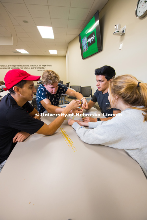 Business students make towers out of raw spaghetti and other materials in class. College of Business photo shoot. August 28, 2018. Photo by Greg Nathan, University Communication.