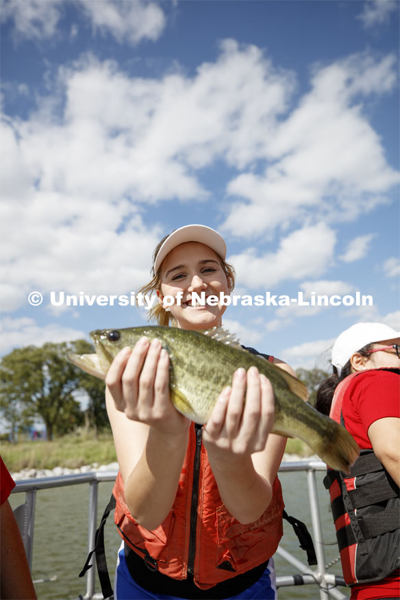 Girl with a fish. School of Natural Resources fish shocking on Bowling Lake northwest of Lincoln. September 12, 2018. Photo by Craig Chandler / University Communication.
