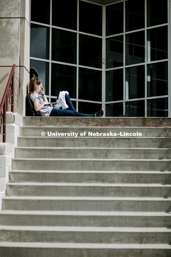 Kelsey Coziahr, senior from Omaha, studies Monday afternoon on the steps of Beadle Hall. September 24, 2018. Photo by Craig Chandler / University Communication.