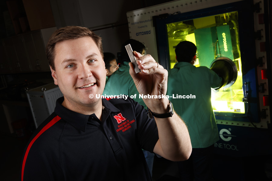 Michael Sealy holds examples of implants that can be made using the 3-D printers in the College of Engineering's NEAT lab. Sealy, an assistant professor of mechanical and materials engineering, is designing magnesium-based implants -- screws, pins, plates