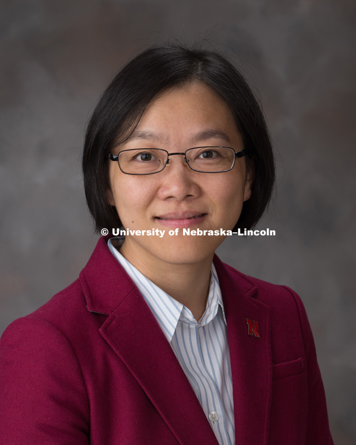 Studio portrait of Yu Jin, Associate Professor of Math, College of Arts and Sciences. October 26, 2018. Photo by Greg Nathan, University Communication.