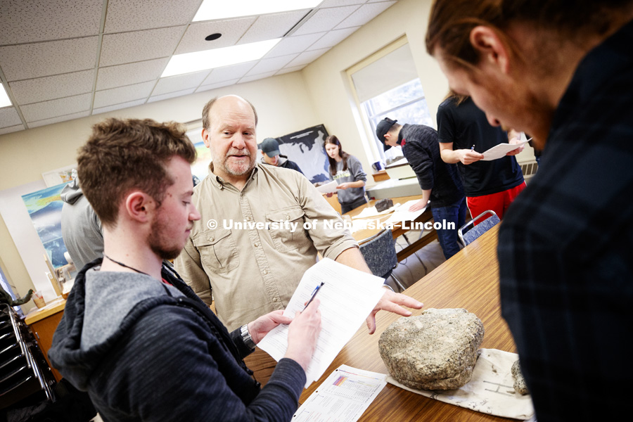 David Harwood answers the questions of Jackson Belva, junior from Colorado Springs, CO. Harwood teaches GEOL 125 - Frontiers in Antarctic Geosciences. Students are classifying rocks and will then add them to their geologic timelines. December 3, 2018. Photo by Craig Chandler / University Communication.