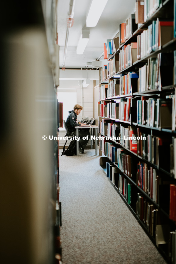 Student Studying in the stacks at Love Library. December 9, 2018. Photo by Justin Mohling, University Communication.