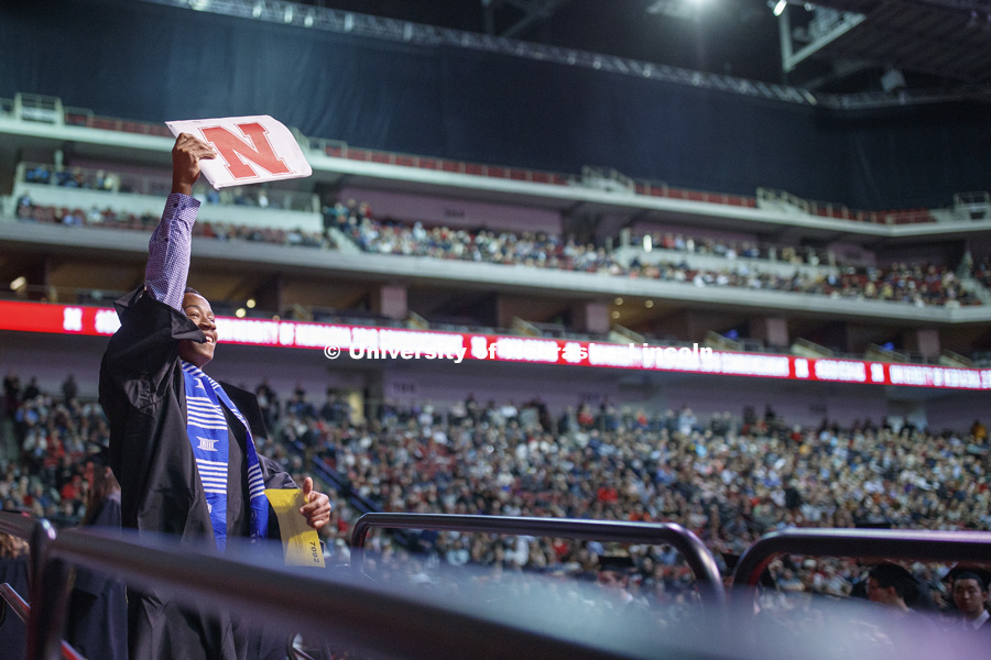 Kyle King shows his diploma to family and friends at the Undergraduate Commencement in Pinnacle Bank Arena. December 15, 2018. Photo by Craig Chandler / University Communication.