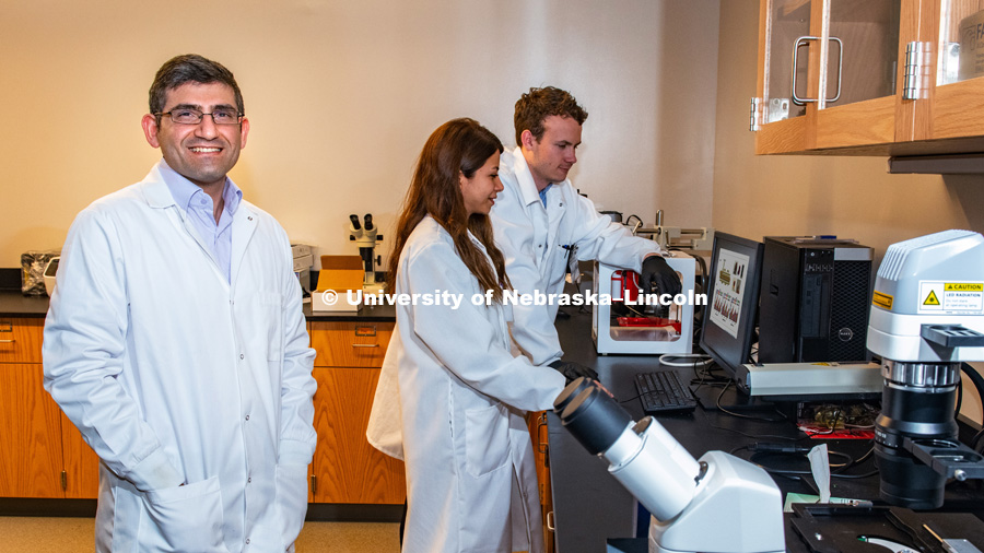 Ali Tamayol (left), Assistant Professor of Engineering, with doctoral students Azadeh Mostafavi (center) and Jacob Quint pictured in lab. January 7, 2019. Photo by Greg Nathan, University Communication.