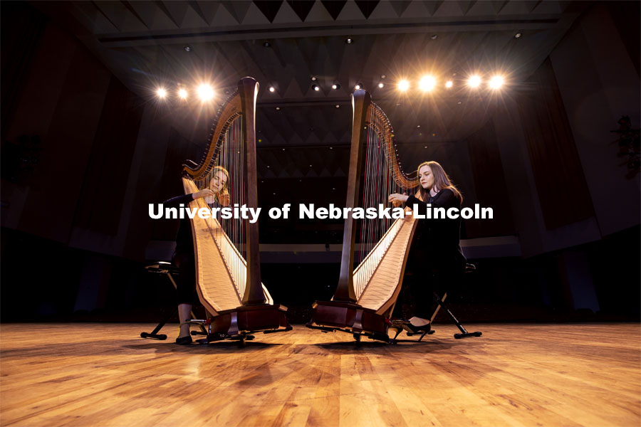 Sarah Brady, left, and Kelly Callahan play the new harps on the Kimball Hall stage. The Glenn Korff School of Music is building its harp program thanks to the recent purchase of two Lyon and Healy harps, one of which was purchased with support from a generous donor. January 28, 2019. Photo by Craig Chandler / University Communication