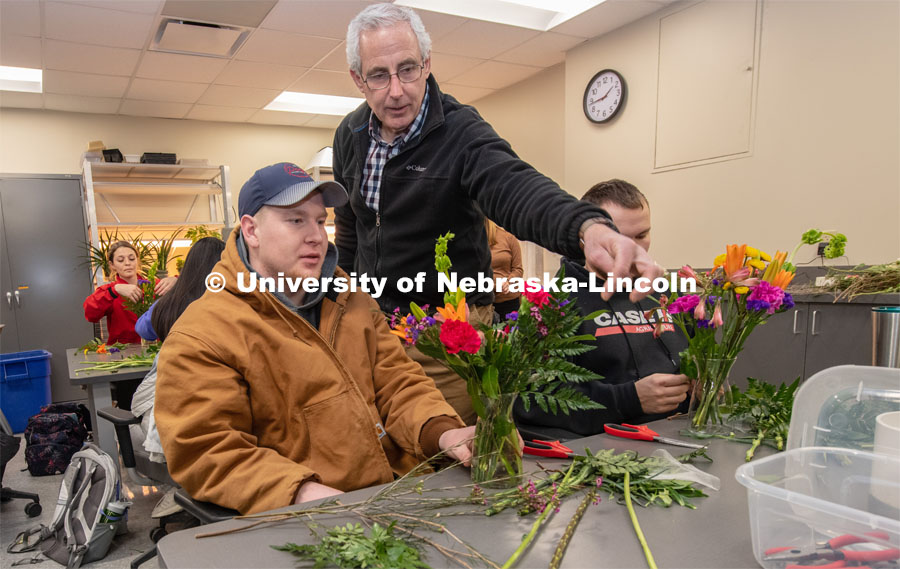 Stacy Adams (center), associate professor of practice in agronomy and horticulture, helps two students create their arrangements in Floral Design class Hort 261- Floral Design 1, in Plant Sciences Hall. Students create floral arrangements. February 26, 2019. Photo by Gregory Nathan / University Communication.