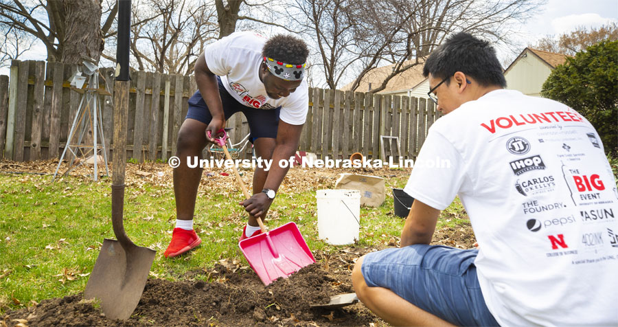 Jada Loro laughs as he tries to use an undersized shovel to move dirt. He and others in the Minority Pre-Health Association painted a shed and cleaned up a yard at their job site. More than 2,500 University of Nebraska–Lincoln students, faculty and staff volunteered for the Big Event on April 6, completing service projects across the community. Now in its 13th year at Nebraska, the Big Event has grown to be the university's single largest student-run community service project. April 6, 2019. Photo by Craig Chandler / University Communication.