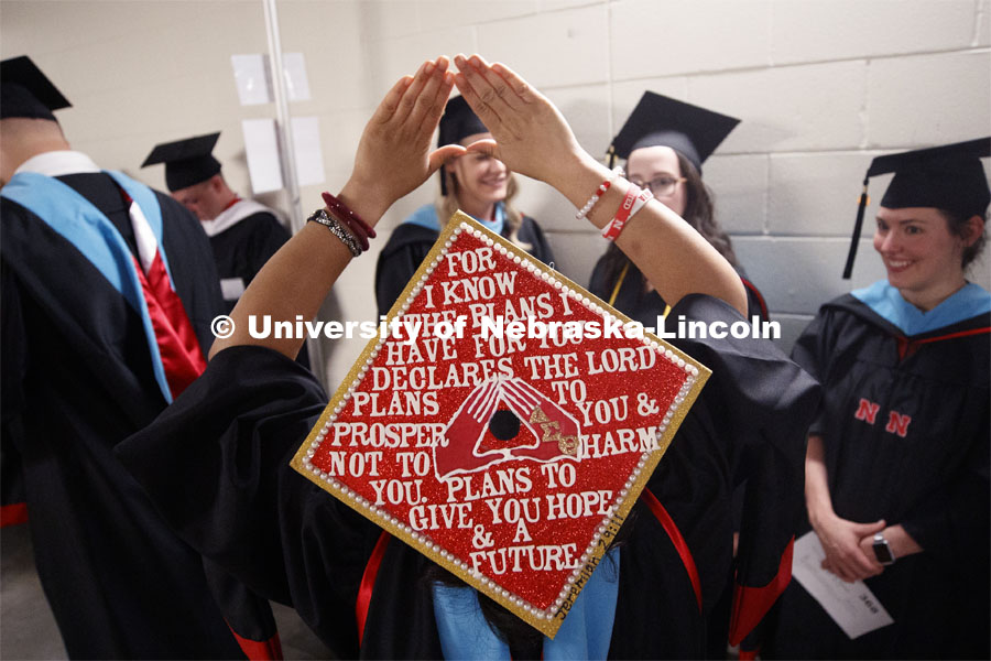 Shirleena Terrell shows her decorated mortar board. 2019 Spring Graduate Commencement in Pinnacle Bank Arena. May 3, 2019. Photo by Craig Chandler / University Communication