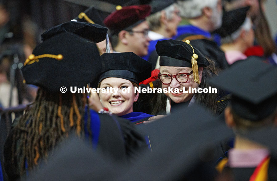Jaclyn Marsh and her advisor Dawn Braithwaite pose for a photo as they walk along a congratulatory line of faculty in the arena. 2019 Spring Graduate Commencement in Pinnacle Bank Arena. May 3, 2019. Photo by Craig Chandler / University Communication