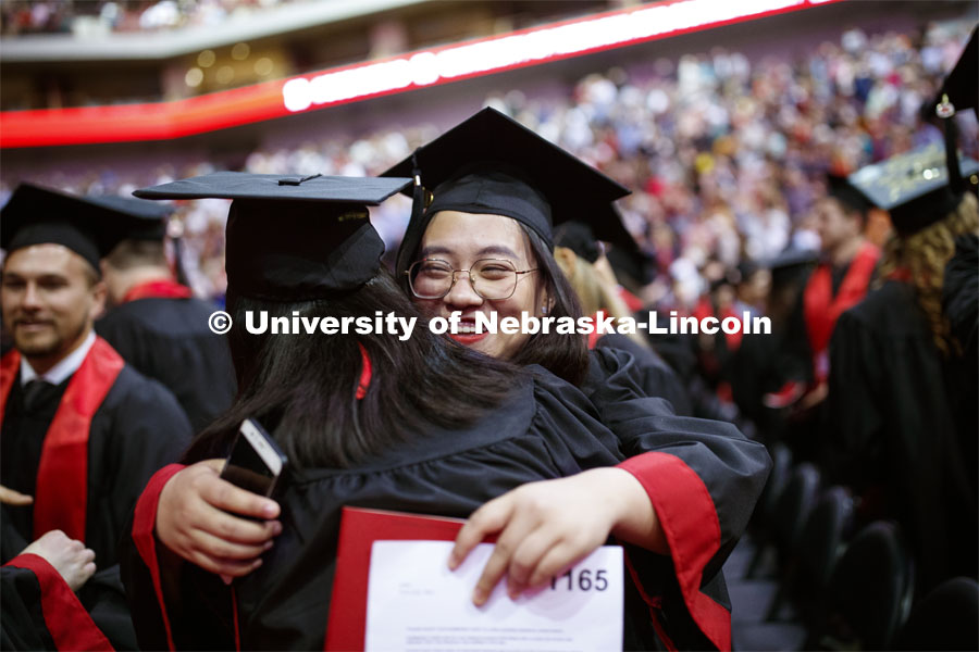 Yutong Mao exchanges greetings with fellow graduates as part of Regent Tim Clare's greeting. Undergraduate commencement at Pinnacle Bank Arena, May 4, 2019.  Photo by Craig Chandler / University Communication.