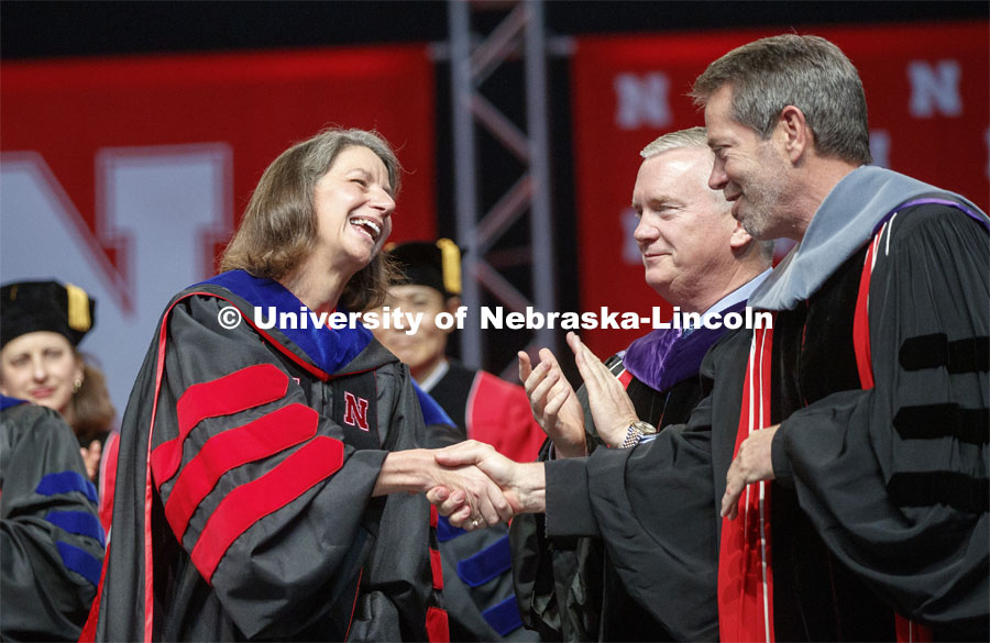 Rebecca Richards-Kortum is congratulated by Regens Time Clare and Jim Pillen after giving the commencement address and accepting the Charles Bessey Medal from Chancellor Ronnie Green. Undergraduate commencement at Pinnacle Bank Arena, May 4, 2019. Photo by Craig Chandler / University Communication.