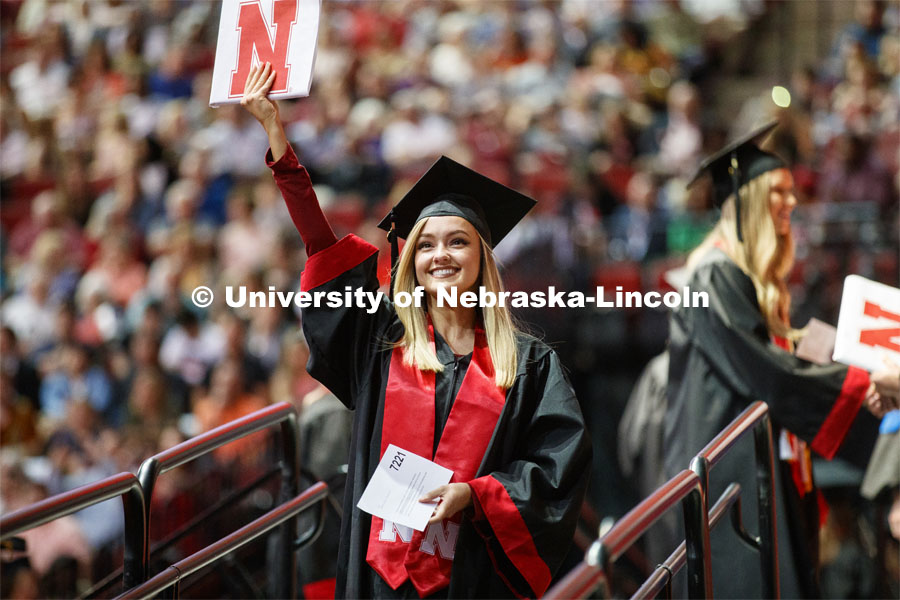 Sydney Mischnick shows off her College of Education and Human Sciences degree to family and friends. Undergraduate commencement at Pinnacle Bank Arena, May 4, 2019. Photo by Craig Chandler / University Communication.