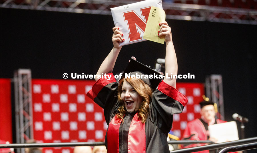 Kiley Goodman waves to family and friends after receiving her Arts and Sciences degree. Undergraduate commencement at Pinnacle Bank Arena, May 4, 2019.  Photo by Craig Chandler / University Communication.