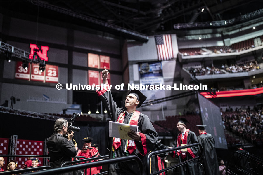 Steven Kirchner gestures to family and friends after receiving his Arts and Sciences degree. Undergraduate commencement at Pinnacle Bank Arena, May 4, 2019. Photo by Craig Chandler / University Communication.