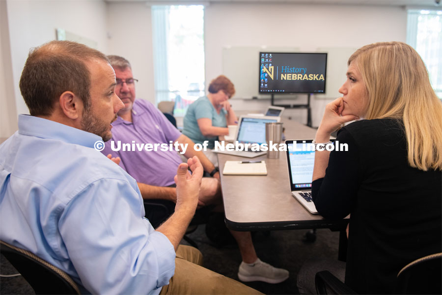Aaron Johnson (left), assistant professor of teaching, learning and education, brainstorms with LPS educators Brad Irvine and Jaci Kellison about ways to incorporate History Harvest into the classroom. June 5, 2019. Photo by Gregory Nathan / University Communication.