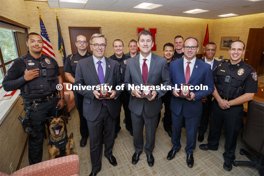 Chancellor Ronnie Green, President Hank Bounds and vice chancellor for Business and Finance Bill Nunez are surrounded by UNL Police Department members after the three were presented commemorative N150 Police Badges. June 20, 2019. Photo by Craig Chandler / University Communication.