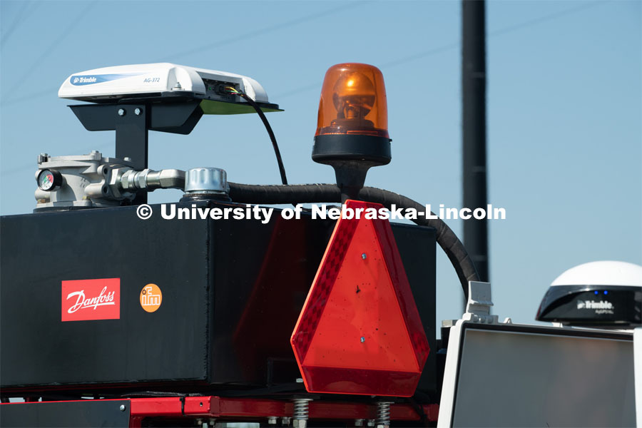 Santosh Pitla, associate professor of advanced machinery systems in the Department of Biological Systems Engineering at the University of Nebraska–Lincoln, is currently developing an autonomous tractor using ground robotics. Pitla and his team are testing their driverless tractor at the Agricultural Research and Development Center (ARDC, MEAD). The autonomous tractors are named Flexible Structured Robotic Vehicle (FlexRo), the tractor is currently used for plant phenotyping, which is measuring the physical characteristics of the plant. According to Pitla, cameras are added to the machine to collect images that characterize plant conditions. Photo for the 2019 publication of the Strategic Discussions for Nebraska magazine. July 17, 2019, Photo by Gregory Nathan / University Communication. 

