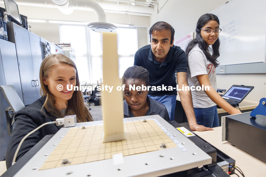 From left: Professor Christine Wittich, Aleece Barnard, senior in civil engineering, Khalid Saifullah, Phd student from Lincoln, and Gabriela Yañez Gonzalez from Anasco, Puerto Rico, watch as a shake table jolts a column and its base. Shake table in the lab of Christine E. Wittich, Assistant Professor, Department of Civil Engineering, in the Prem S. Paul Research Center at Whittier School. July 23, 2019. Photo by Craig Chandler / University Communication.