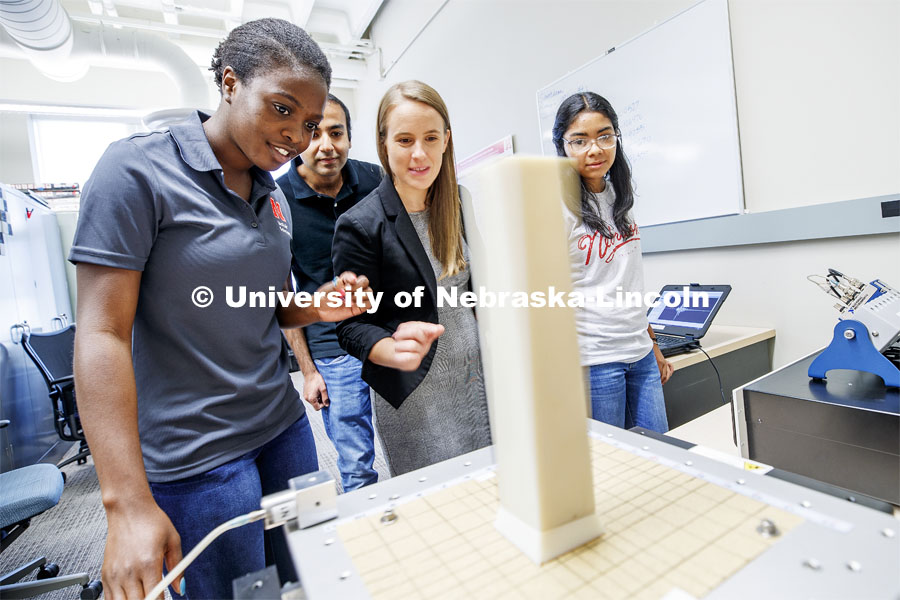 From left: Aleece Barnard, senior in civil engineering, Khalid Saifullah, Phd student from Lincoln, Professor Christine Wittich, and Gabriela Yañez Gonzalez from Anasco, Puerto Rico, watch as a shake table jolts a column and its base. Shake table in the lab of Christine E. Wittich, Assistant Professor, Department of Civil Engineering, in the Prem S. Paul Research Center at Whittier School. July 23, 2019. Photo by Craig Chandler / University Communication.