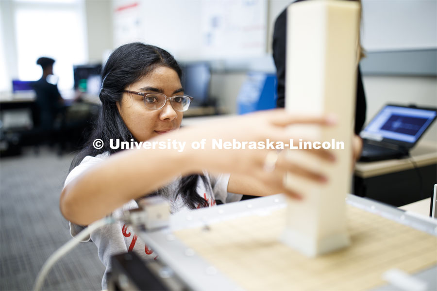 Yañez Gonzalez from Anasco, Puerto Rico, adjusts her test column, Shake table in the lab of Christine E. Wittich, Assistant Professor, Department of Civil Engineering, in the Prem S. Paul Research Center at Whittier School. July 23, 2019. Photo by Craig Chandler / University Communication.