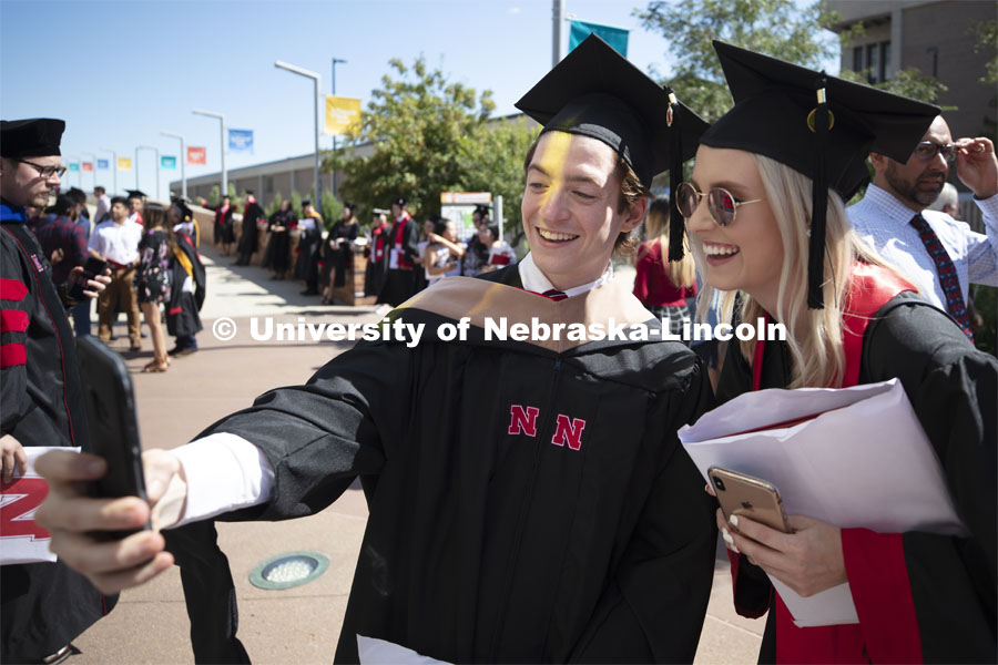 Benjamin Smith and Madison Roan take a selfie following commencement. 2019 Summer Commencement at Pinnacle Bank Arena. August 17, 2019. Photo by Craig Chandler / University Communication.