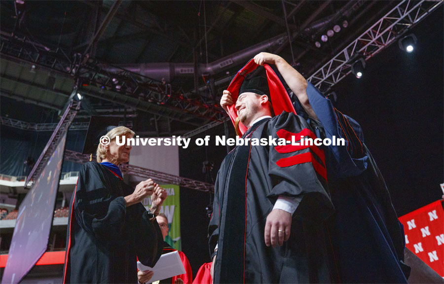 Sue Sheridan reacts as her doctoral student, Andrew White is hooded Saturday. 2019 Summer Commencement at Pinnacle Bank Arena. August 17, 2019. Photo by Craig Chandler / University Communication.