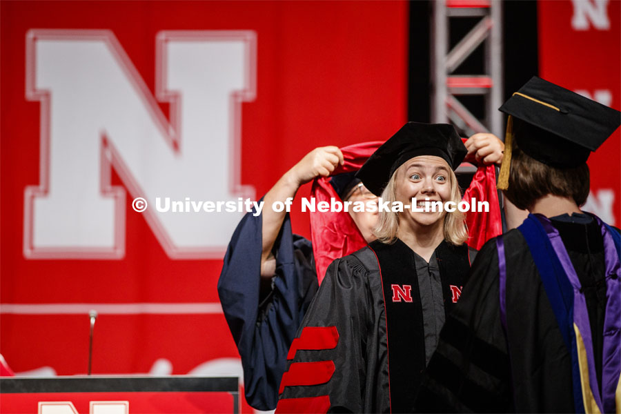 Amy Mantz smiles at her advisor Angie Pannier as she receives her doctoral hood. 2019 Summer Commencement at Pinnacle Bank Arena. August 17, 2019. Photo by Craig Chandler / University Communication.