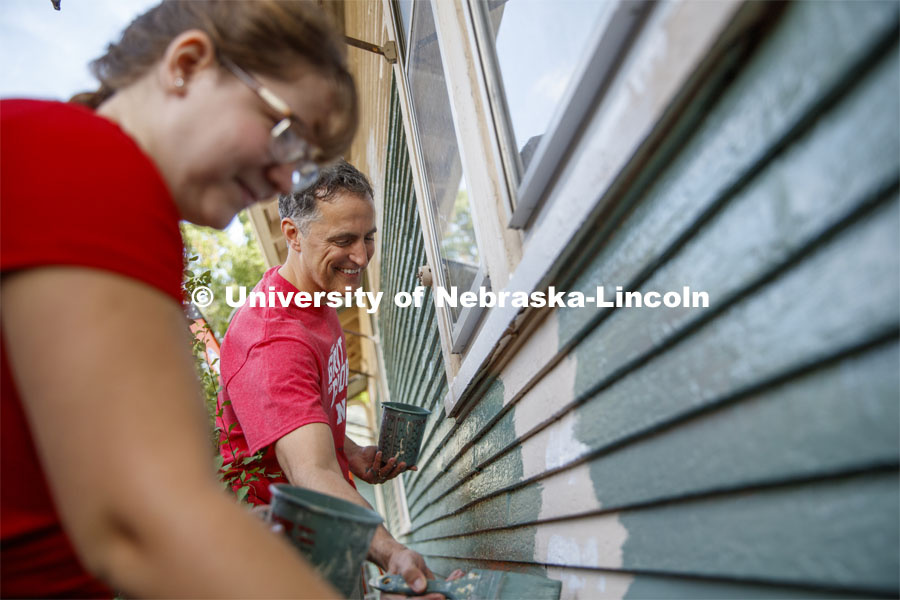 Richard Moberly, Interim Executive Vice Chancellor and Chief Academic Officer paints alongside incoming law students at a home at 30th and Vine. First year law students, faculty and staff paint two Lincoln houses. The painting is a yearly tradition for the incoming students. August 24, 2019. Photo by Craig Chandler / University Communication.