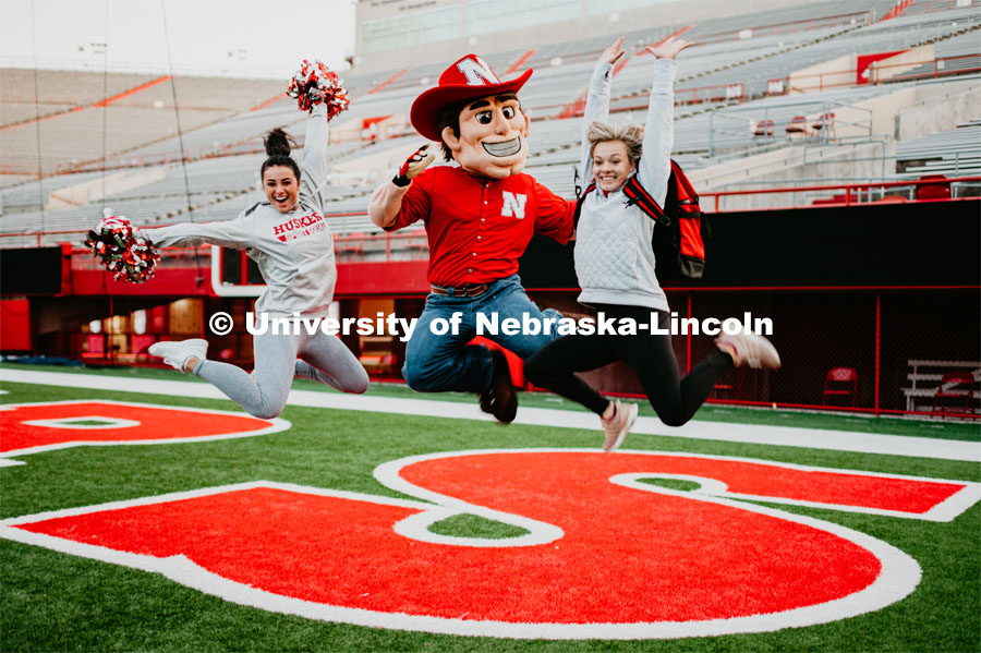 Herbie jumping with some fans. Herbie Husker photo shoot, pictured throughout Memorial Stadium. September 13, 2019. Photo by Justin Mohling / University Communication.