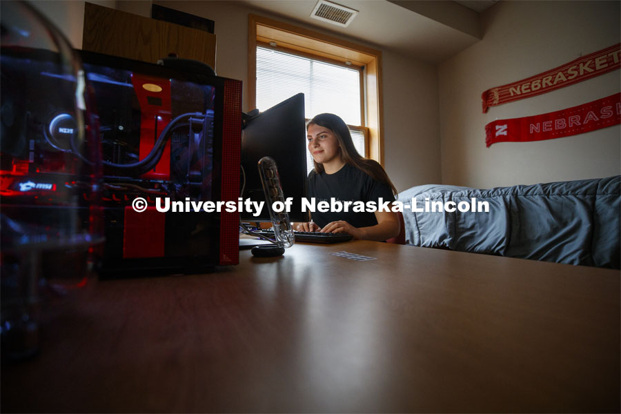 Young woman studying on her computer in her Kauffman Academic Residential Center dorm room. Raikes school photo shoot. September 25, 2019. Photo by Craig Chandler / University Communication.
