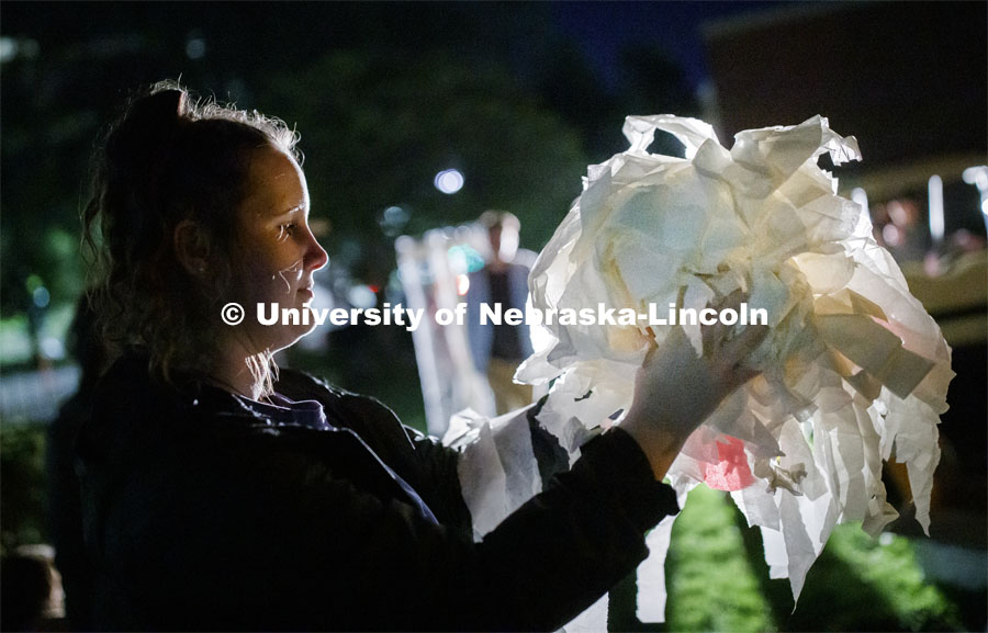 Madi Mohar, a sophomore Chi Omega sorority member, carries a handful of tissue for one of the columns that is part of the display on Sigma Chi lawn. 2019 Homecoming display decorations. October 3, 2019. Photo by Craig Chandler / University Communication.