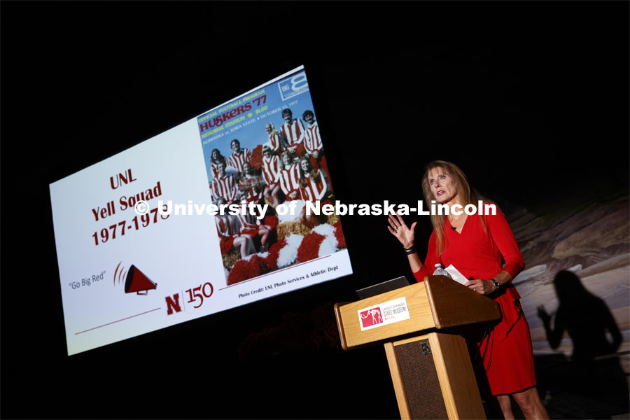 Debra Kleve White, alumni and former member of then-named yell squad, presents the Homecoming Nebraska Lecture, “Louise Pound and the History of UNL School Spirit”. On the screen is a game program with her squad's photo. October 4, 2019. Photo by Craig Chandler / University Communication.