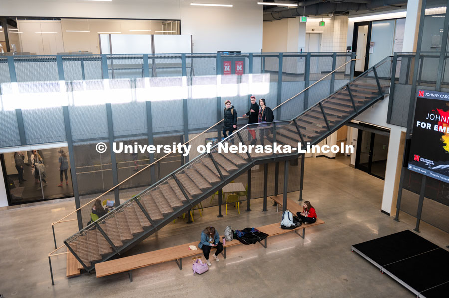 Megan Elliott, Director of the Johnny Carson School for Emerging Media Arts, walks down the staircase with students in the main area of the building. November 12, 2019. Photo by Justin Mohling / University Communication.
