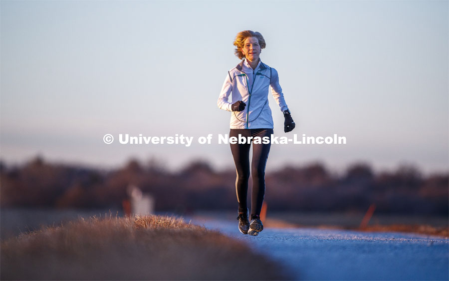 Sue Sheridan, director of the Nebraska Center for Research on Children, Youth, Families and Schools, is on a mission to run marathons or half-marathons in all 50 states. Sheridan is running in support of her nonprofit, Elevating Haitian Education. Sue is pictured running at Holmes Lake Park in Lincoln, Nebraska. December 4, 2019. Photo by Craig Chandler / University Communication.