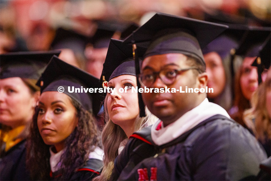 Sarah Arten watches the greetings on the video screen at the start of the Graduate Commencement and Hooding at the Pinnacle Bank Arena. December 20, 2019. Photo by Craig Chandler / University Communication.