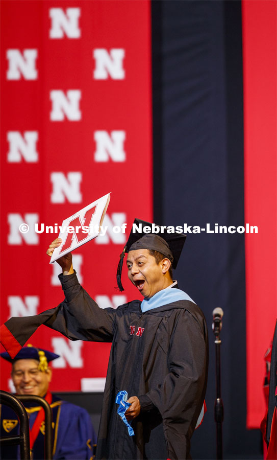 Hector de Jesus Palala Martinez celebrates his masters degree. Graduate Commencement and Hooding at the Pinnacle Bank Arena. December 20, 2019. Photo by Craig Chandler / University Communication.