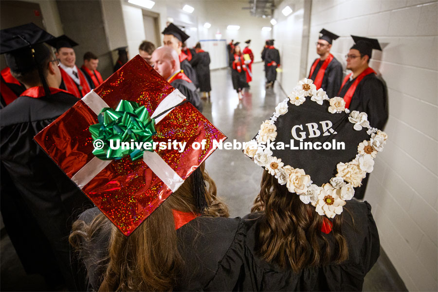 Ashley Willis and Kaylee Land show off their decorated mortar boards. December Undergraduate commencement at Pinnacle Bank Arena. December 21, 2019. Photo by Craig Chandler / University Communication.