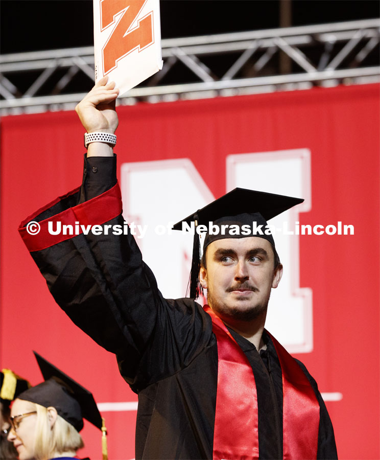 Jackson Walker shows off his college of business diploma to family and friends. December Undergraduate commencement at Pinnacle Bank Arena. December 21, 2019. Photo by Craig Chandler / University Communication.