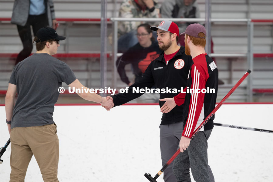 Adam Schlichtmann congratulates a member of the competing team on a match well played. Nebraska's nationally-ranked curling club host its first bonspiel at the John Breslow Ice Hockey Center this weekend. The bonspiel — or tournament — featured seven traveling schools from across the Midwest. February 1, 2020. Photo by Gregory Nathan / University Communication.