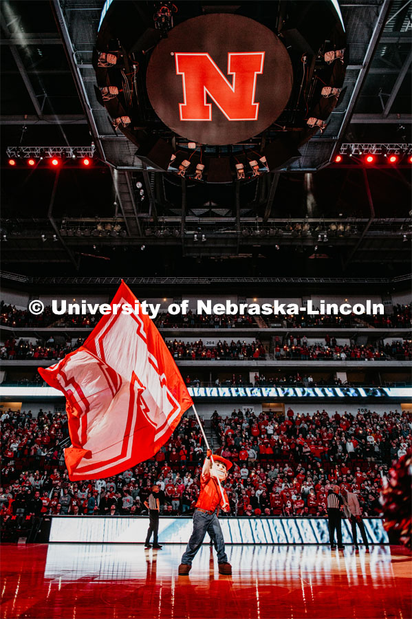 Herbie Husker waves a large N flag at center court to rally the fans. Nebraska vs. Michigan State University men’s basketball game. February 20, 2020.  Photo by Justin Mohling / University Communication.