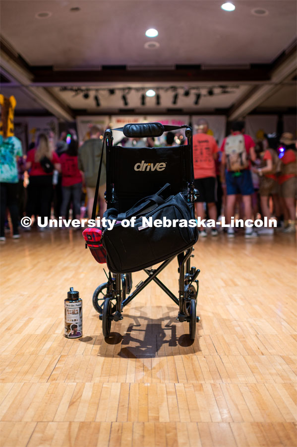 A wheelchair of one of the miracle children sits empty as they are in the group enjoying themselves. University of Nebraska–Lincoln students exceeded their goal, raising $235,229 during the annual HuskerThon on Feb. 29. Also known as Dance Marathon, the event is part of a nationwide fundraiser supporting Children’s Miracle Network Hospitals. The annual event, which launched in 2006, is the largest student philanthropic event on campus. The mission of the event encourages participants to, “dance for those who can’t.” All funds collected by the Huskers benefit the Children’s Hospital and Medical Center in Omaha. February 29, 2020. Photo by Justin Mohling / University Communication.