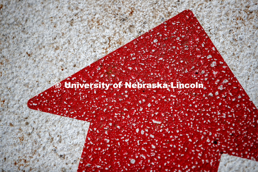 A red arrow on the sidewalk points students to the Husker Hub located in the Love Library. March 2, 2020. Photo by Craig Chandler / University Communication.